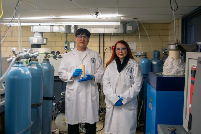 From left to right: University of Toronto PhD candidate Jaesuk (Jay) Paeng stands next to Professor Gisele Azimi and holds the team’s newly designed electrochemical cell that can withstand temperatures up to 1600 degrees Celsius while electrochemically removing contaminants from steel using slag-based electrolyte. Credit: photo by Safa Jinje